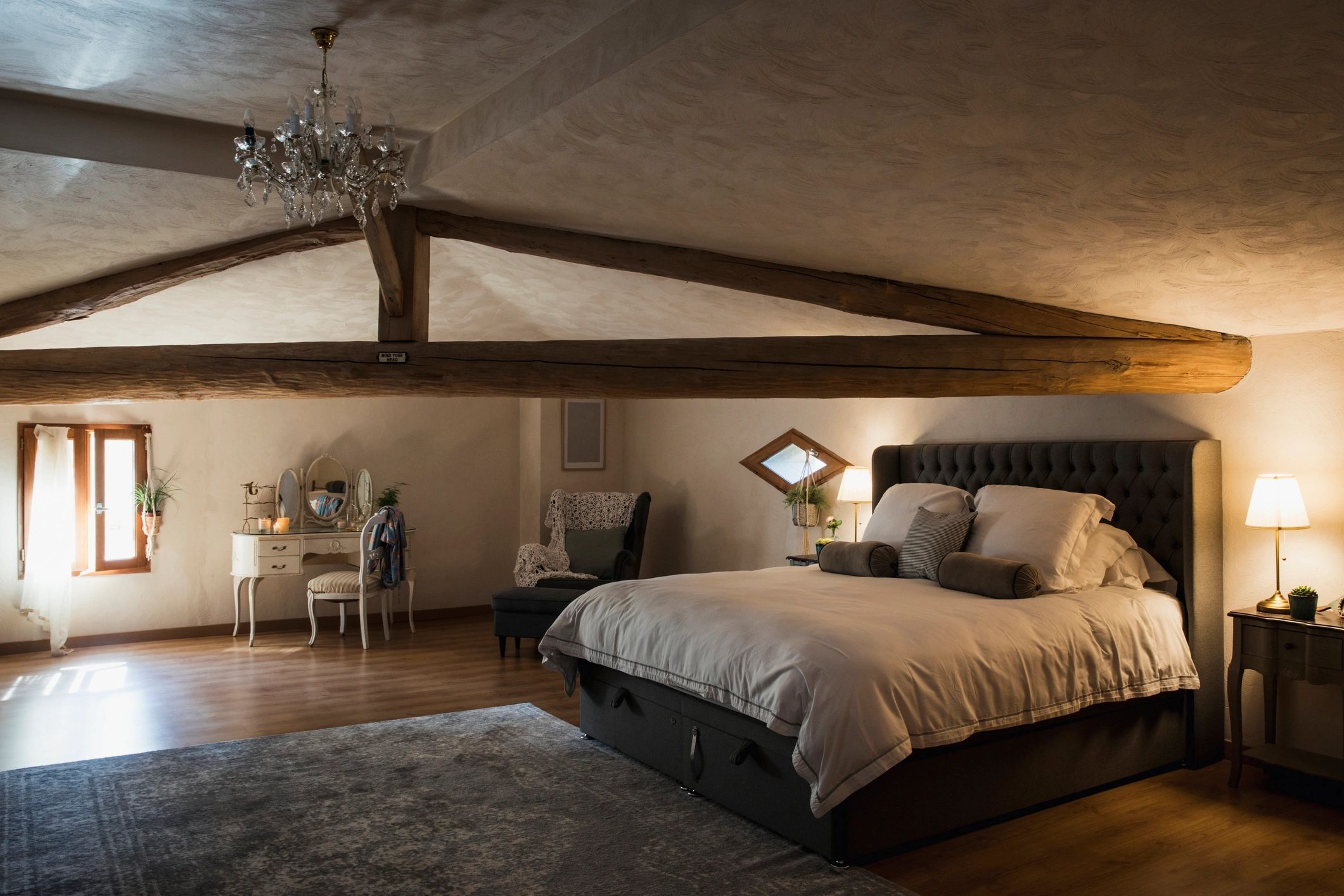 Comfortable modern bedroom with wood flooring